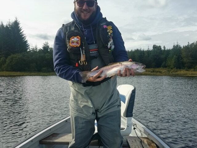 A fine perfect rainbow trout caught on a fly shop hopper