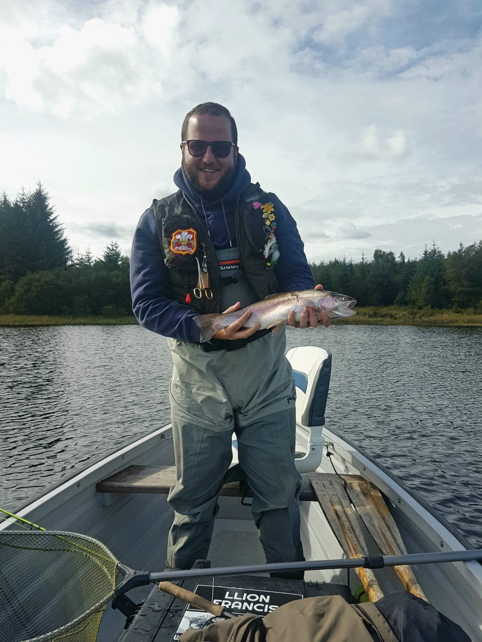 A fine perfect rainbow trout caught on a fly shop hopper