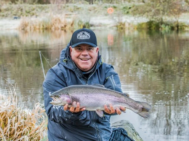 Jim Crawford with a cracking small still water rainbow trout