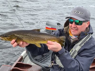 Man holding up brown trout